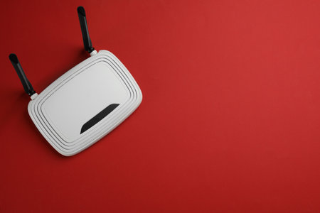 Modern WiFi router on red background, top view. Space for textの写真素材