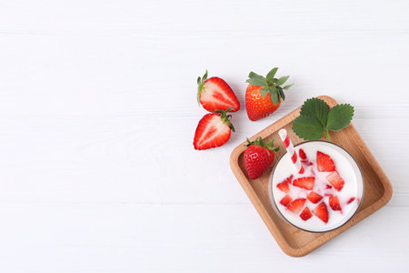 Delicious drink with strawberries on white wooden table, flat lay. Space for textの写真素材