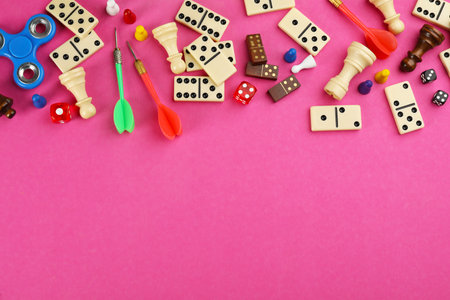 Components of board games on pink background, flat lay. Space for textの写真素材