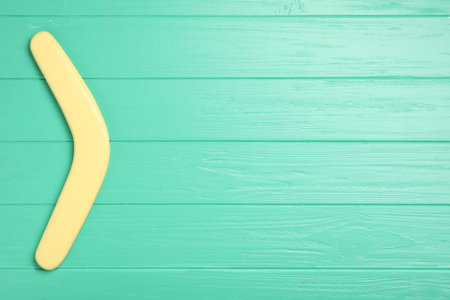 Boomerang on turquoise wooden background, top view. Space for textの写真素材