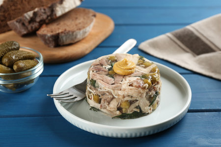 Delicious aspic with meat on blue wooden tableの写真素材