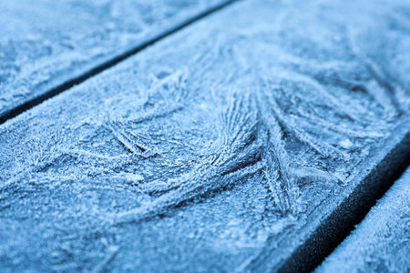 Beautiful hoarfrost on wooden surface, closeup viewの写真素材
