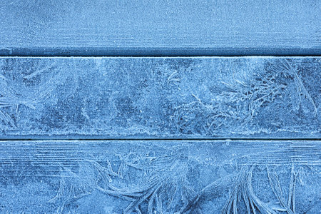 Beautiful hoarfrost on wooden background, top viewの写真素材
