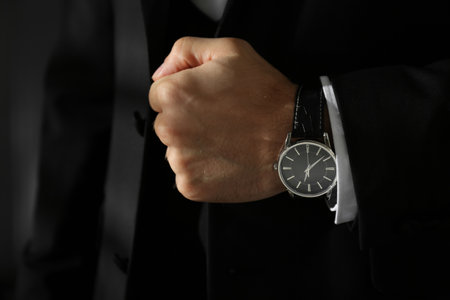 Businessman with luxury wrist watch on blurred background, closeupの写真素材