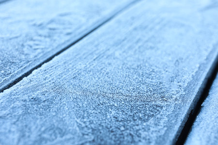 Beautiful hoarfrost on wooden surface, closeup viewの写真素材
