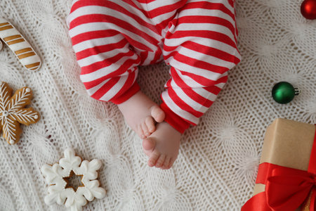 Cute little baby and Christmas decorations on blanket, top viewの写真素材