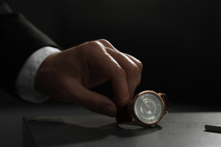 Man luxury wrist watch on table, putting closeup