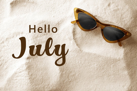 hello july. Stylish sunglasses on sand, top viewの写真素材