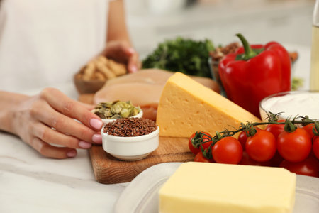 Woman with different products at table, closeup. Keto dietの写真素材