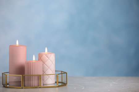 Burning candles on light gray marble table. space for textの写真素材