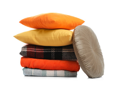 Stylish soft pillows and blankets on white backgroundの写真素材