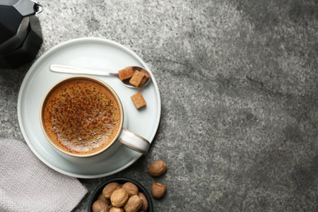 Coffee with nutmegs on gray table, flat lay. Space for textの写真素材