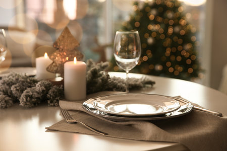 Festive table setting in room decorated for Christmasの写真素材