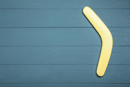 Boomerang on gray wooden background, top view. Space for textの写真素材