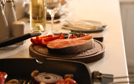Tasty salmon steak on countertop in kitchenの写真素材