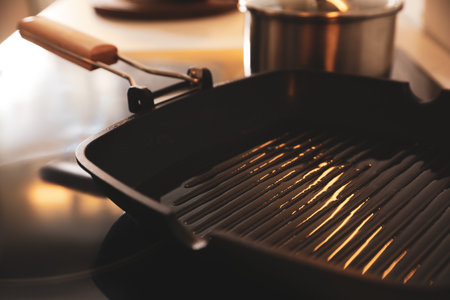 Frying pan with cooking oil on stoveの写真素材