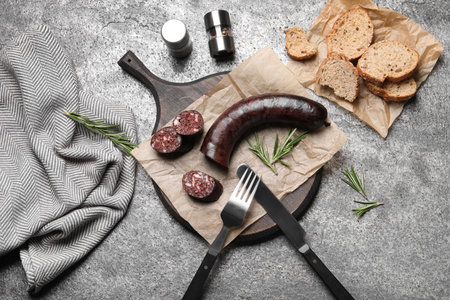 Tasty blood sausage with rosemary on gray table, flat layの写真素材
