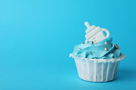 Baby shower cupcake with topper on light blue background, space for textの写真素材