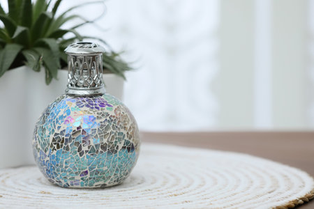 Burning catalytic purifying lamp on table, space for textの写真素材