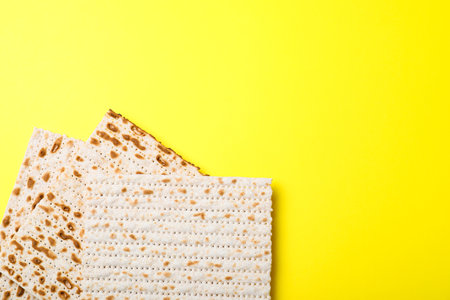 Traditional matzos on yellow background, flat lay. Space for textの写真素材
