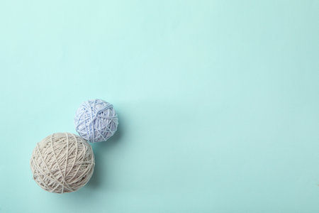 Soft colorful woolen yarns on light blue background, flat lay. Space for textの写真素材