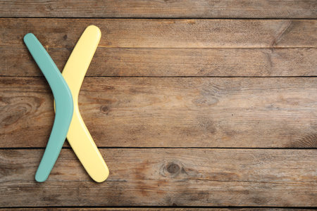 Boomerangs on wooden background, flat lay. Space for textの写真素材