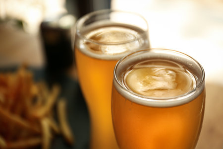 Glasses of fresh cool beer in cafe, closeupの写真素材