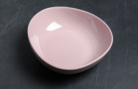 New clean bowl on black slate tableの写真素材