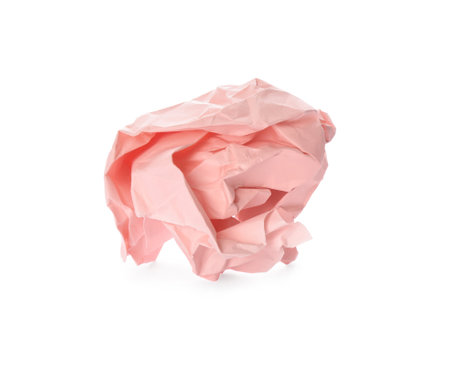 Crumpled sheet of light pink paper isolated on whiteの写真素材