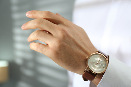 Man with luxury wrist watch on blurred background, closeupの写真素材