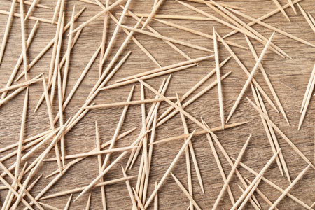 Disposable toothpicks on wooden background, flat layの写真素材