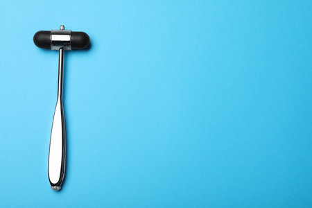 Reflex hammer on light blue background, top view with space for text. Nervous system diagnosticの写真素材
