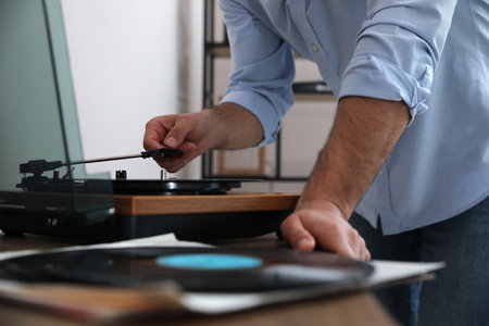 Man using turntable at home, closeup viewの写真素材