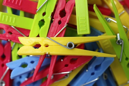 Colorful plastic clothes pins as background, top viewの写真素材