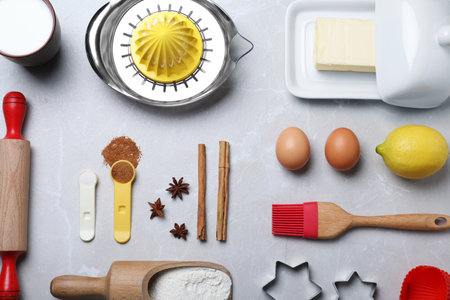 Cooking utensils and ingredients on light marble table, flat layの写真素材