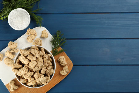 Flat lay composition with dehydrated soy meat on blue wooden table. Space for textの写真素材