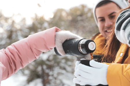Happy family with thermo outdoors on winter day, closeup. christmas holidays