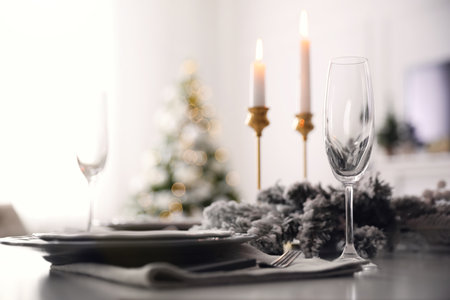 Table with festive setting and candles at homeの写真素材
