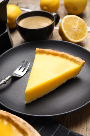 Slice of delicious homemade lemon pie on wooden tableの写真素材