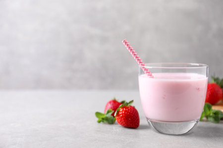 Delicious strawberry drink on light gray table. Space for textの写真素材