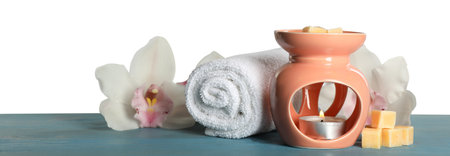 Composition with aroma lamp on blue wooden table against light gray background, space for textの写真素材