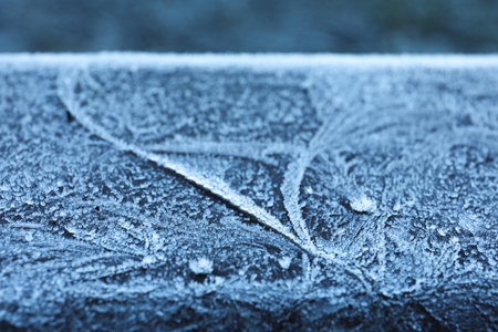Plank covered with beautiful hoarfrost on blurred background, closeupの写真素材