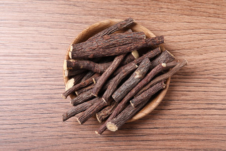 Dried sticks of liquorice root on wooden table, top viewの写真素材