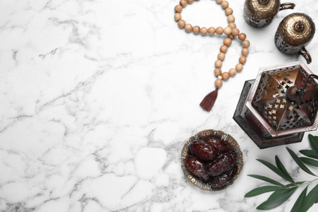 Flat lay composition with Arabic lantern on white marble table. Space for text