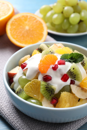 Delicious fruit salad with yogurt on table, closeupの写真素材