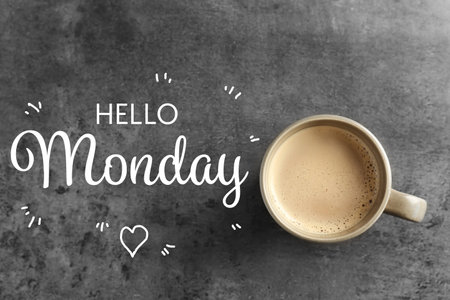 Cup of hot aromatic coffee and phrase Hello Monday on gray background, top viewの写真素材