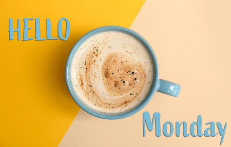 Cup of hot aromatic coffee and phrase Hello Monday on color background, top viewの写真素材