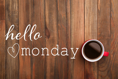 Cup of hot aromatic coffee and phrase Hello Monday on wooden background, top viewの写真素材