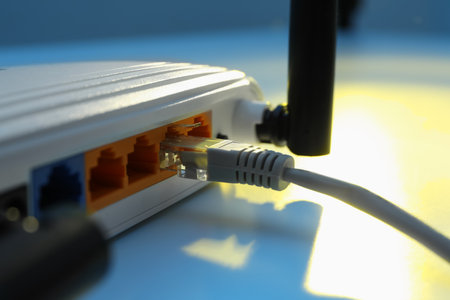 Connected cable to router on white table, closeup. wireless internet communicationの写真素材