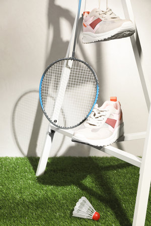 Composition with badminton equipment and sneakers against light backgroundの写真素材